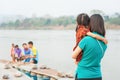 An asian little girl in her motherÃ¢â¬â¢s arms